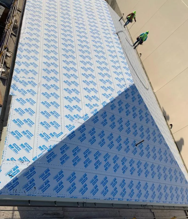 Professional roofers installing underlayment on a metal roof in Christiansburg